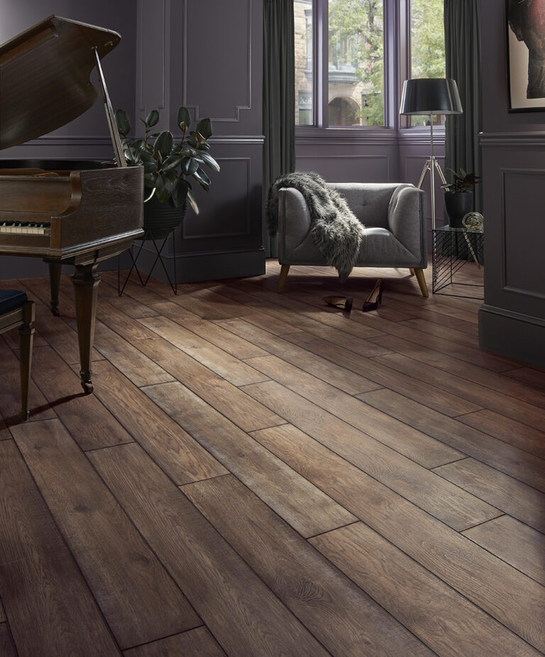 A stylish living room featuring a grand piano, cozy seating, and natural light through large windows.